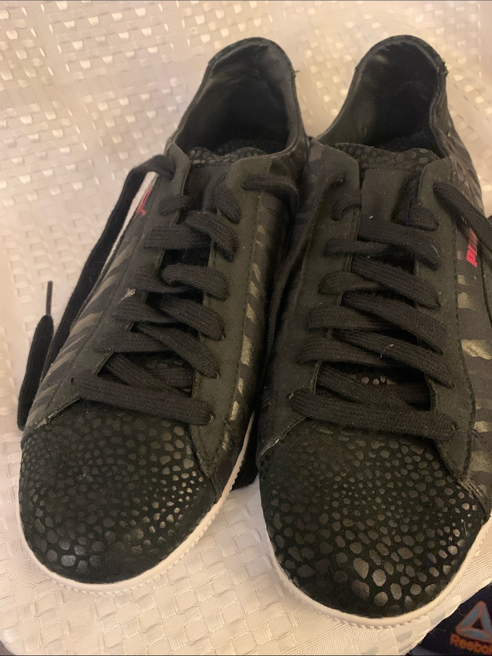 Women’s black and pink low rise Puma sneakers, size 8.